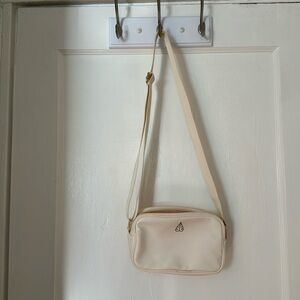Biossance brand new white adjustable crossbody bag with zipper